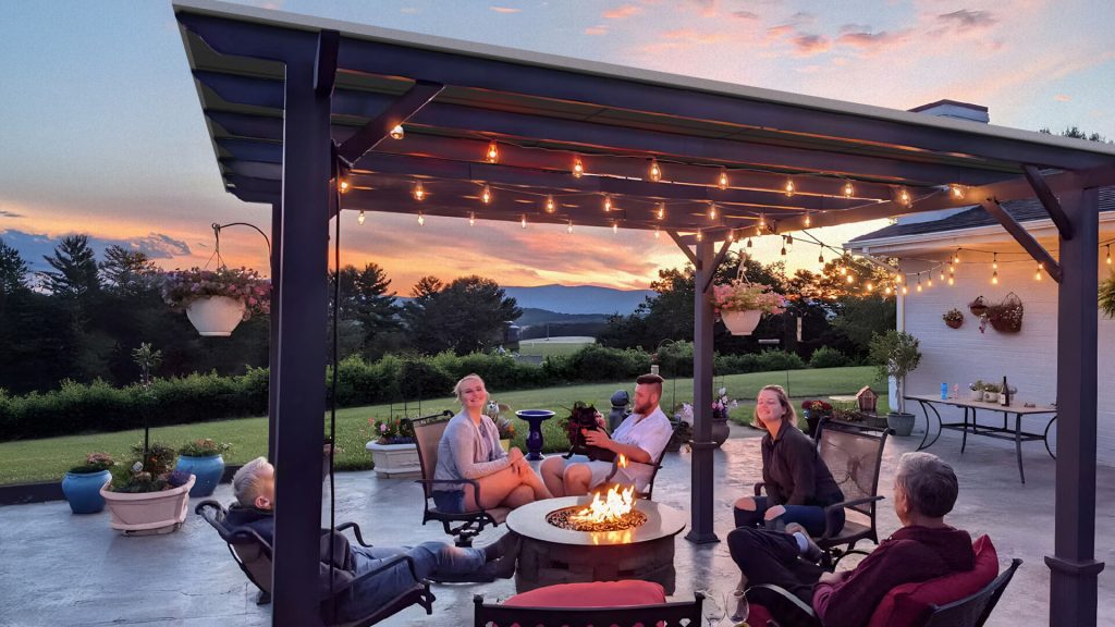 Family enjoying the late afternoon under a pergola covered with solar panels.